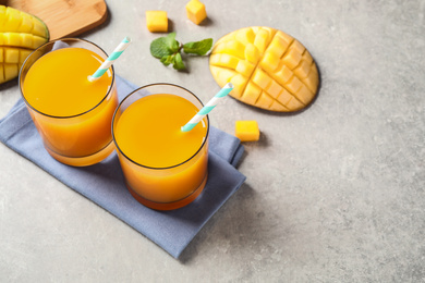 Photo of Fresh delicious mango drink on light table