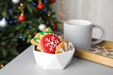 Photo of Bowl with tasty homemade Christmas cookies on table