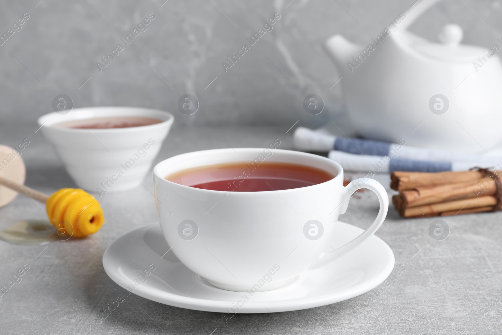 Photo of Freshly brewed rooibos tea on grey table