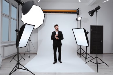 Handsome model posing in modern studio. Professional photo session