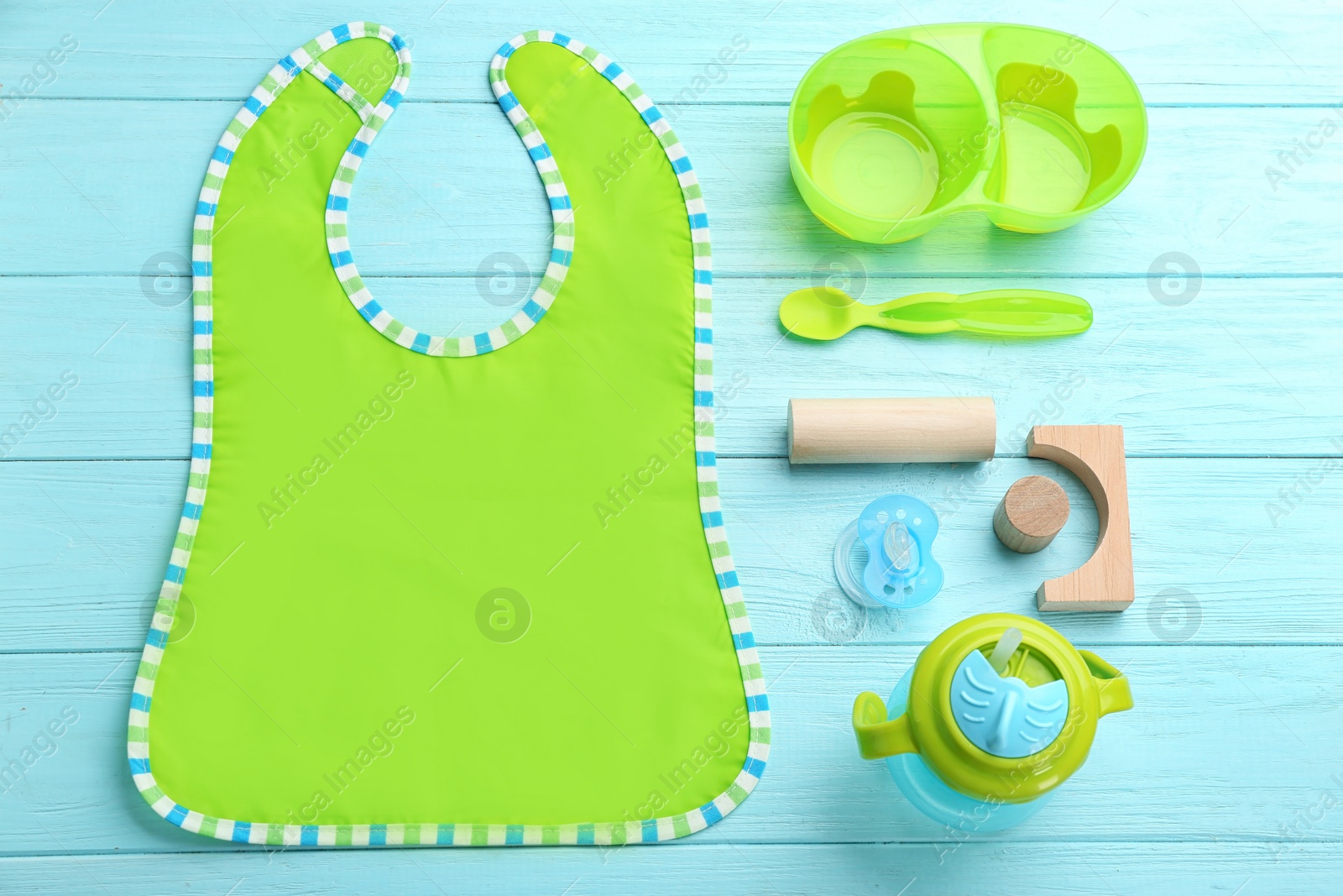 Photo of Flat lay composition with baby tableware for food on wooden background