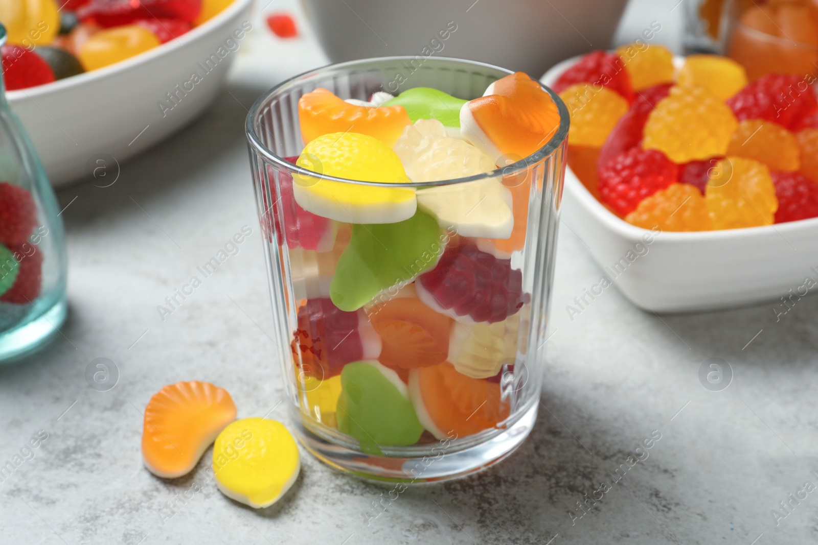 Photo of Delicious gummy candies on light grey table