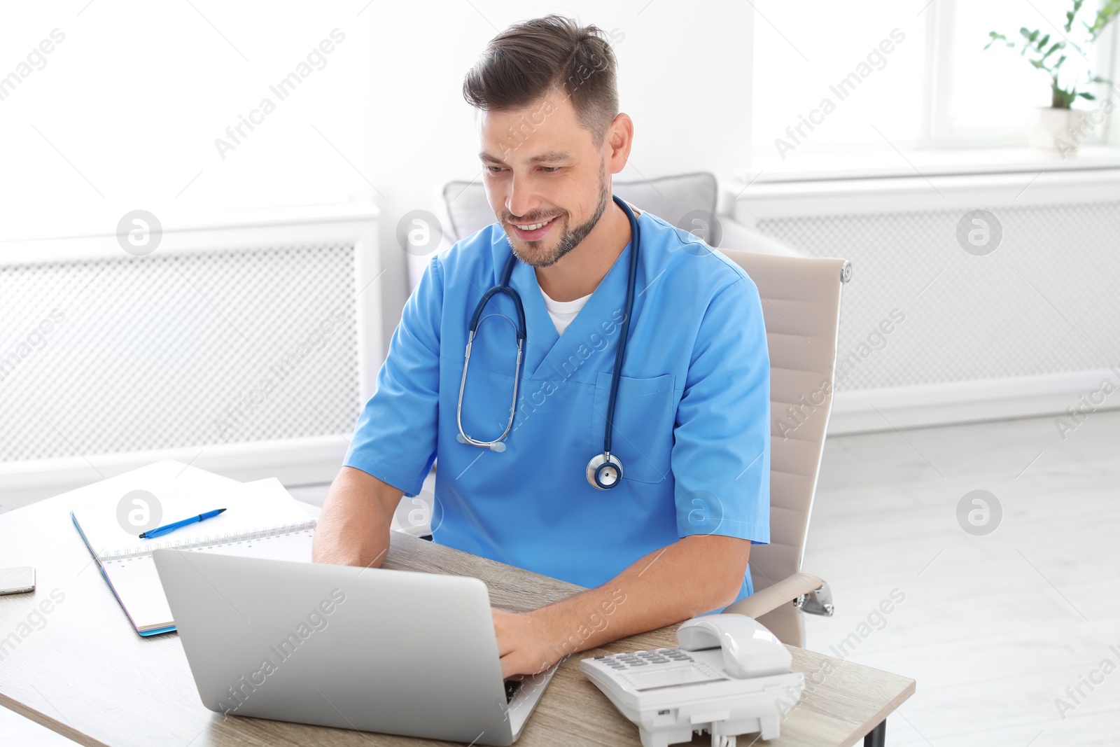 Photo of Male medical assistant at workplace in clinic. Health care service