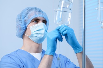 Photo of Nurse setting up IV drip in hospital