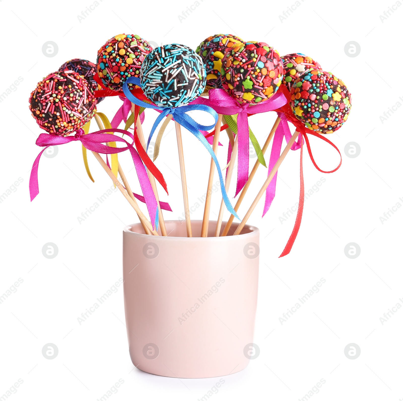 Photo of Sweet cake-pops in glass on white background