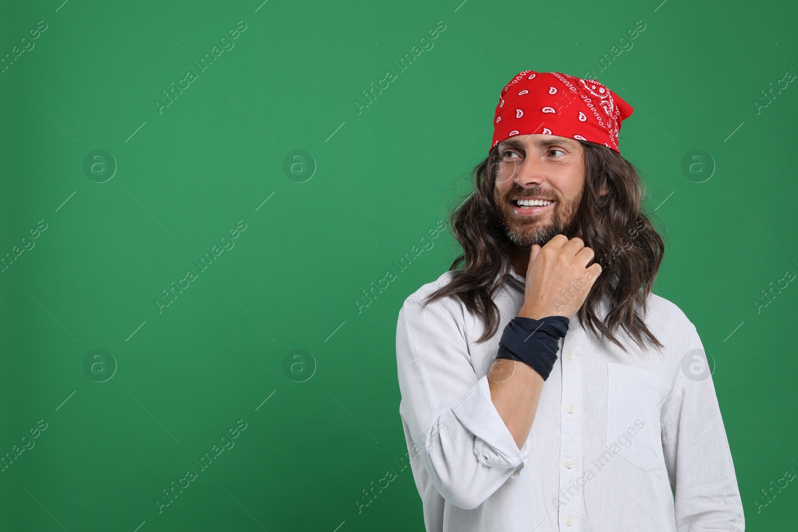 Photo of Stylish hippie man on green background, space for text