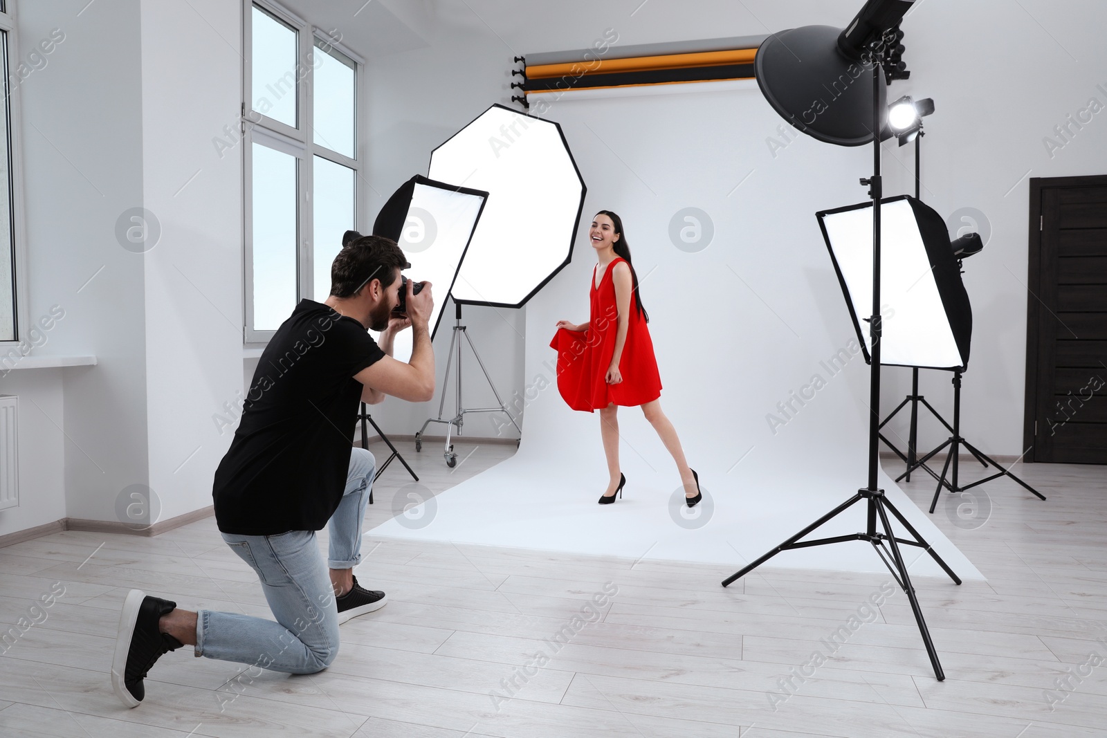 Photo of Beautiful young model posing for professional photographer in studio