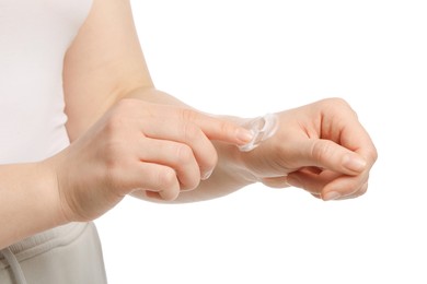 Photo of Woman applying ointment onto her hand on white background, closeup