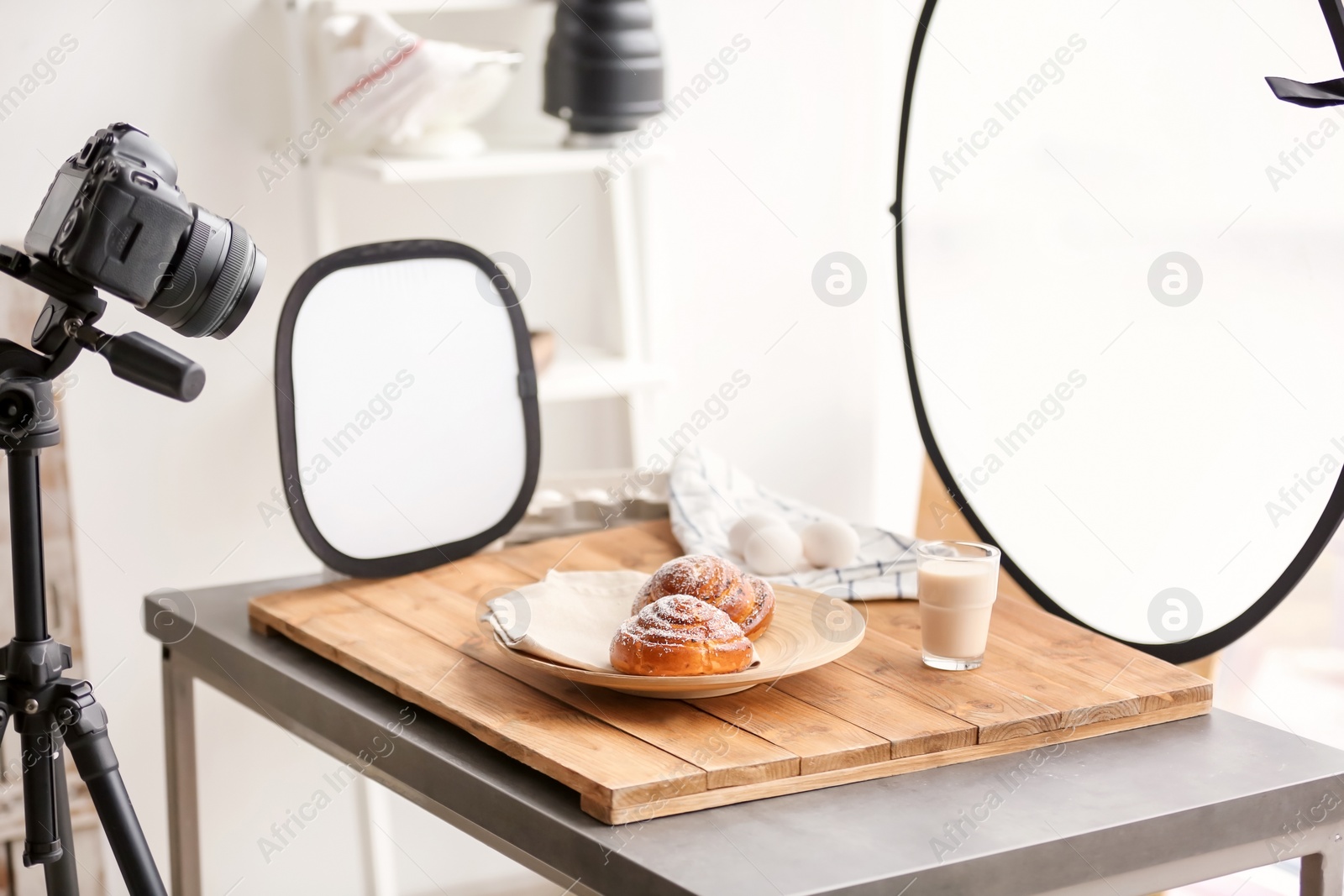 Photo of Professional camera on tripod and food composition in photo studio