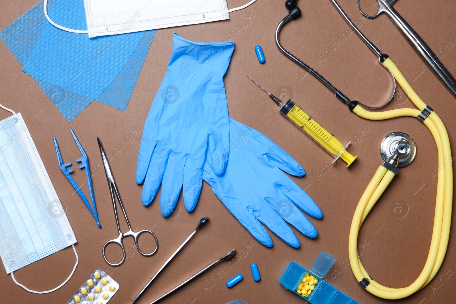 Photo of Flat lay composition with medical gloves on color background