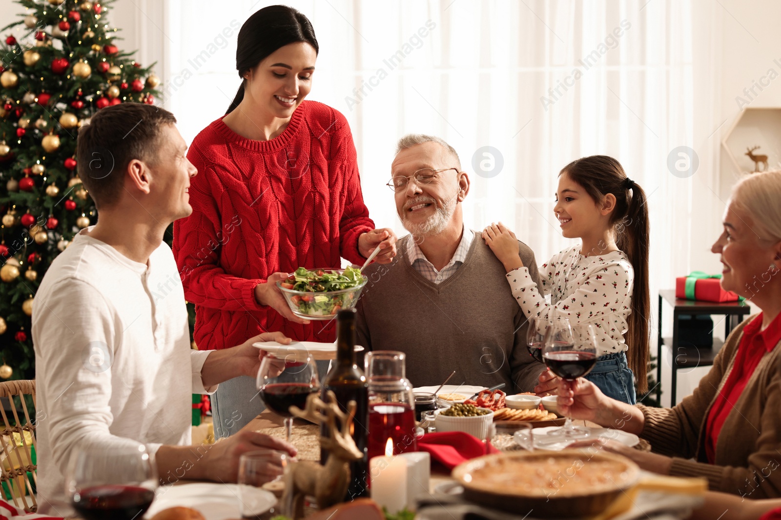 Photo of Happy family enjoying festive dinner at home. Christmas celebration