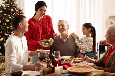 Happy family enjoying festive dinner at home. Christmas celebration