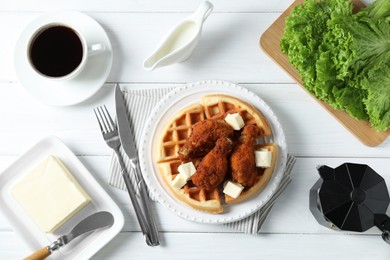 Delicious Belgium waffles served with fried chicken and butter on white table, flat lay