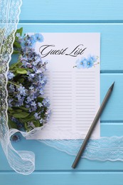 Guest list, pencil, lace ribbon and flowers on light blue wooden table, flat lay. Space for text