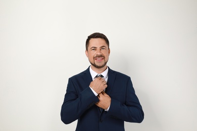 Photo of Portrait of handsome man in suit on light background