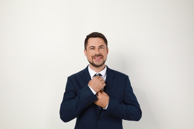 Portrait of handsome man in suit on light background