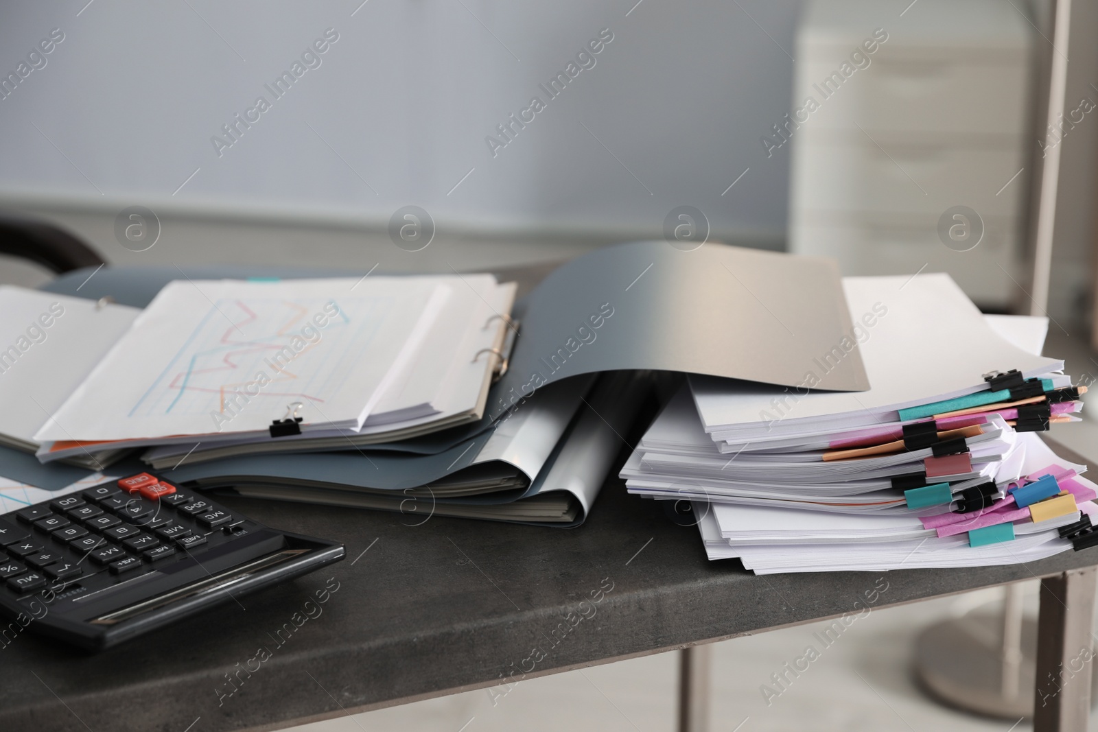 Photo of Folders with documents and calculator on office table