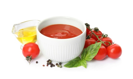 Composition with bowl of tomato sauce and vegetables isolated on white