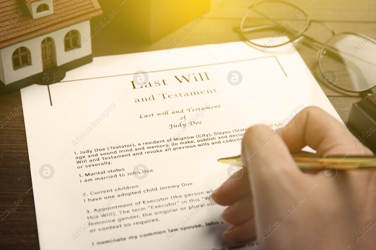 Image of Woman reading Last Will and Testament at table, closeup