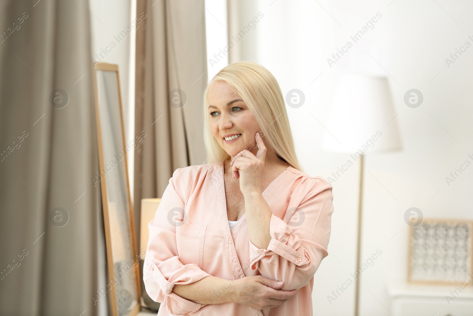 Photo of Portrait of happy mature woman at home