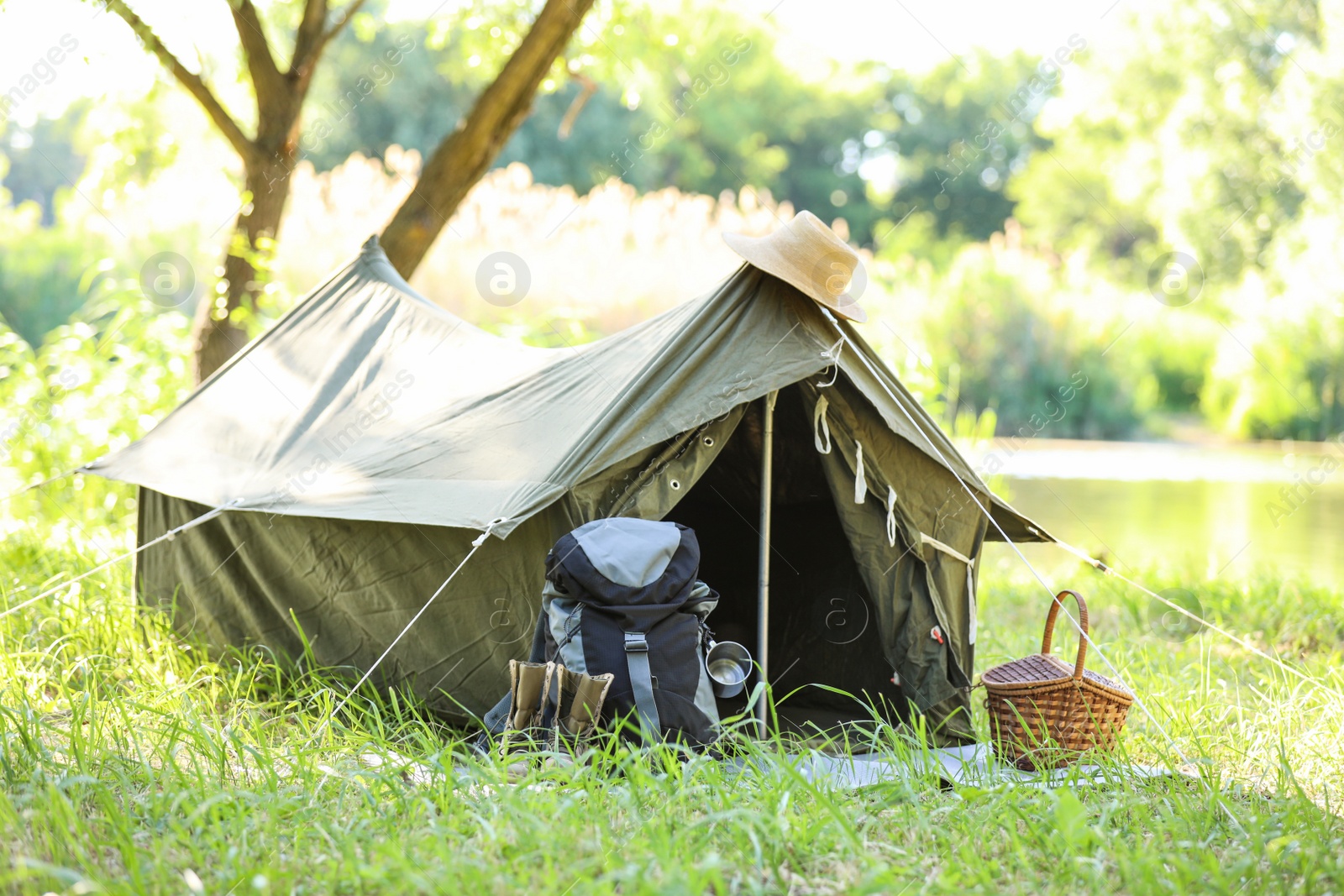 Photo of Traveling gear near tent outdoors. Summer camp