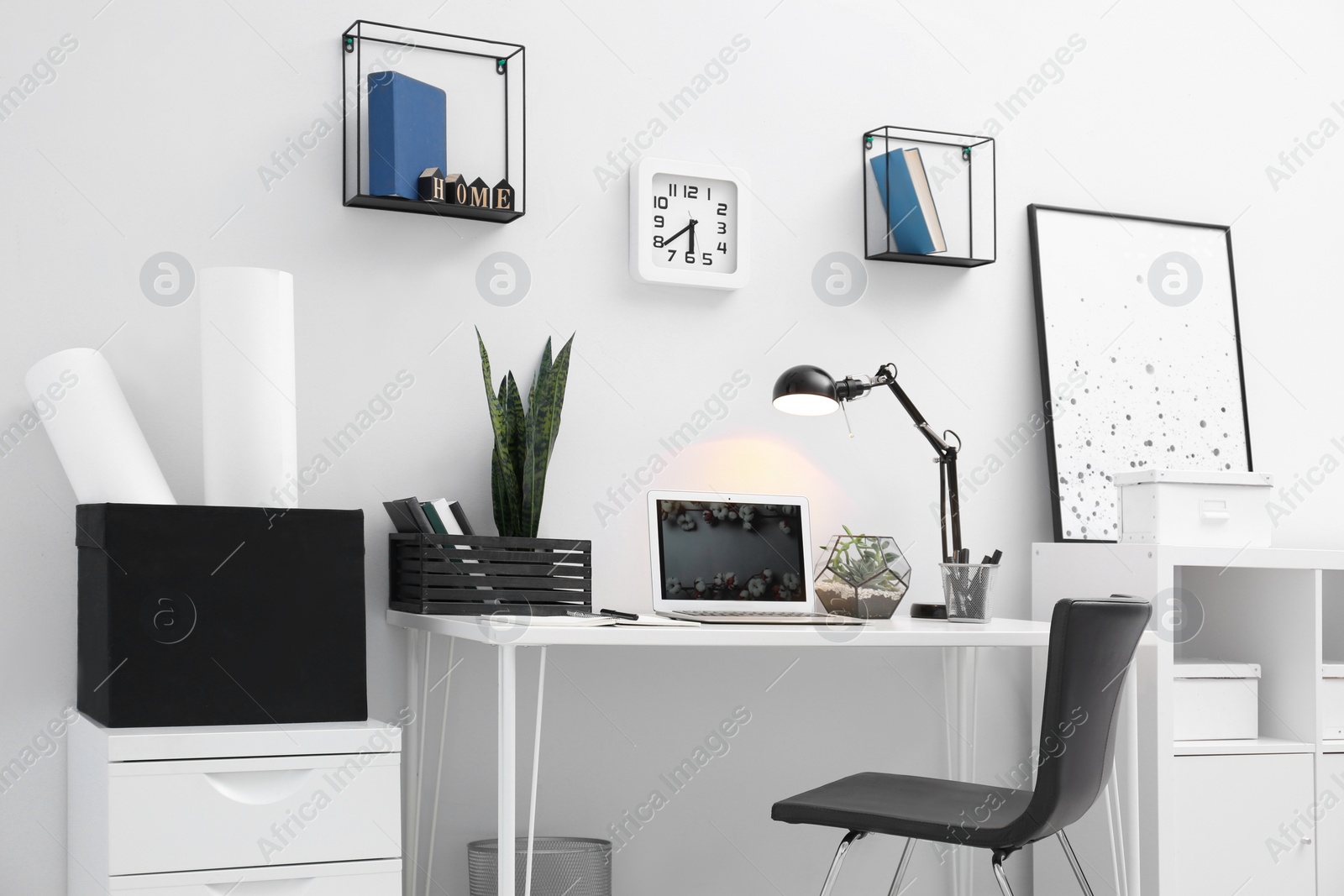 Photo of Comfortable workplace with modern laptop on desk. Home office