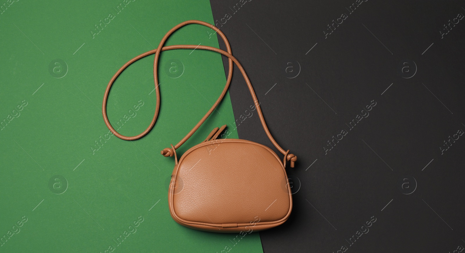 Photo of Stylish woman's bag on color background, top view. Space for text