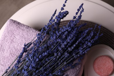 Photo of Beautiful lavender flowers, terry towel and soap on white table, flat lay