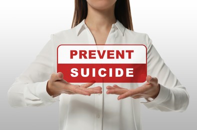 Image of Woman holding virtual sign with words Prevent suicide on white background, closeup