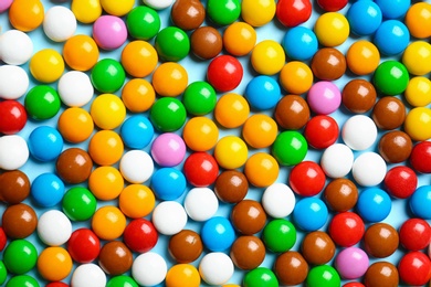 Photo of Many colorful delicious candies as background, top view
