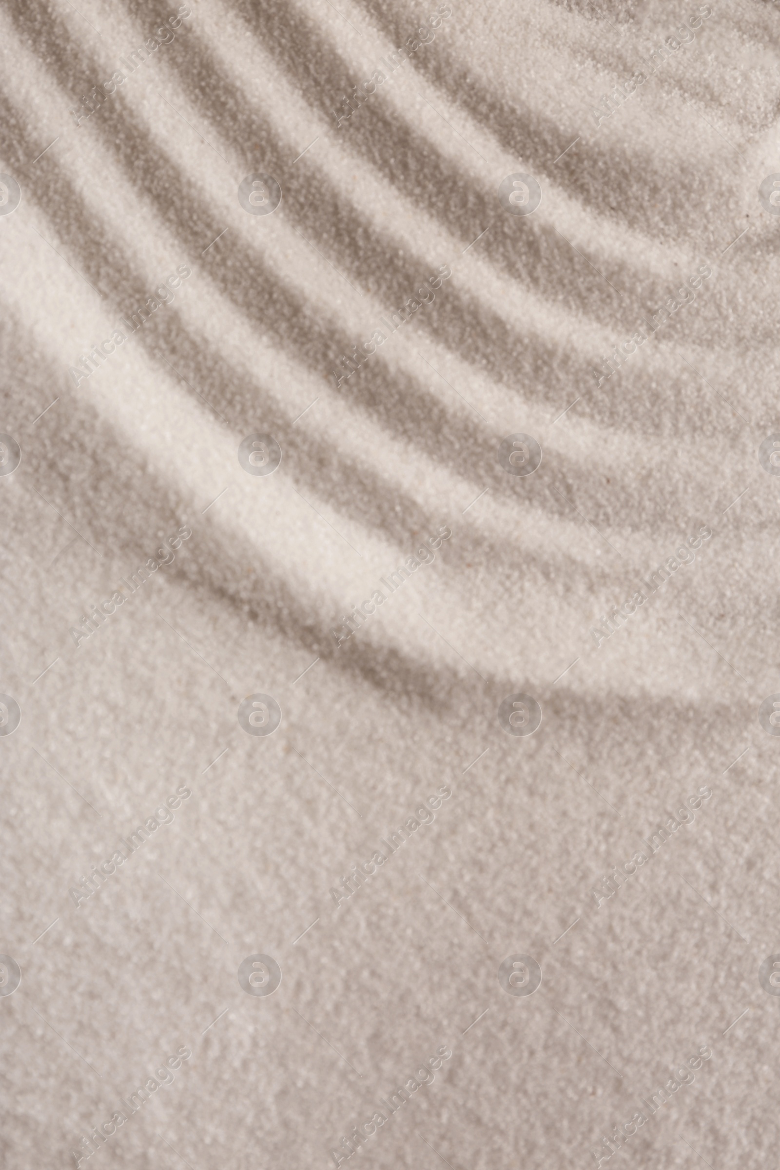 Photo of White sand with pattern as background, closeup. Concept of zen and harmony