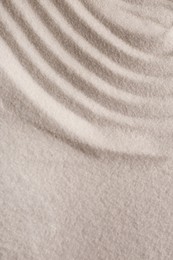 White sand with pattern as background, closeup. Concept of zen and harmony