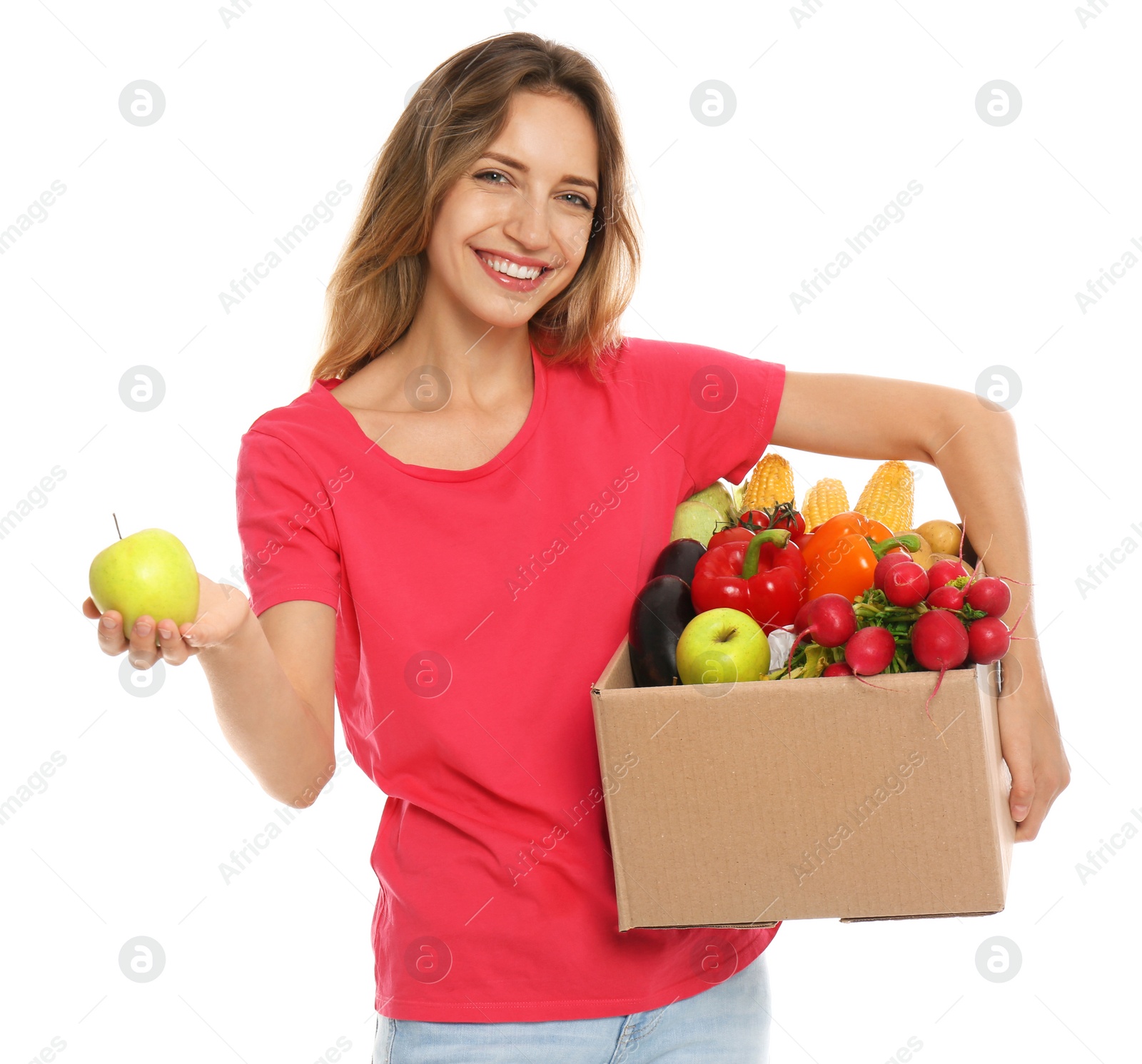 Photo of Young woman with box of fresh vegetables on white background