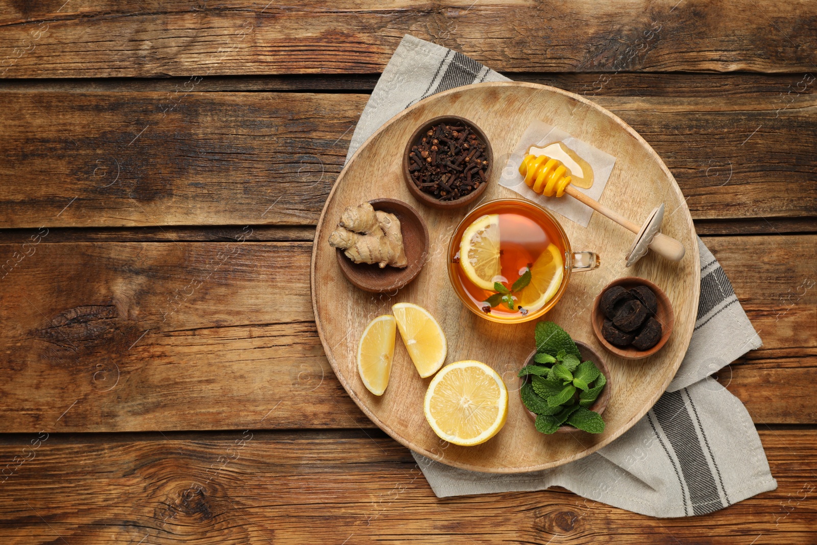 Photo of Tray with immunity boosting drink and ingredients on wooden table, top view. Space for text