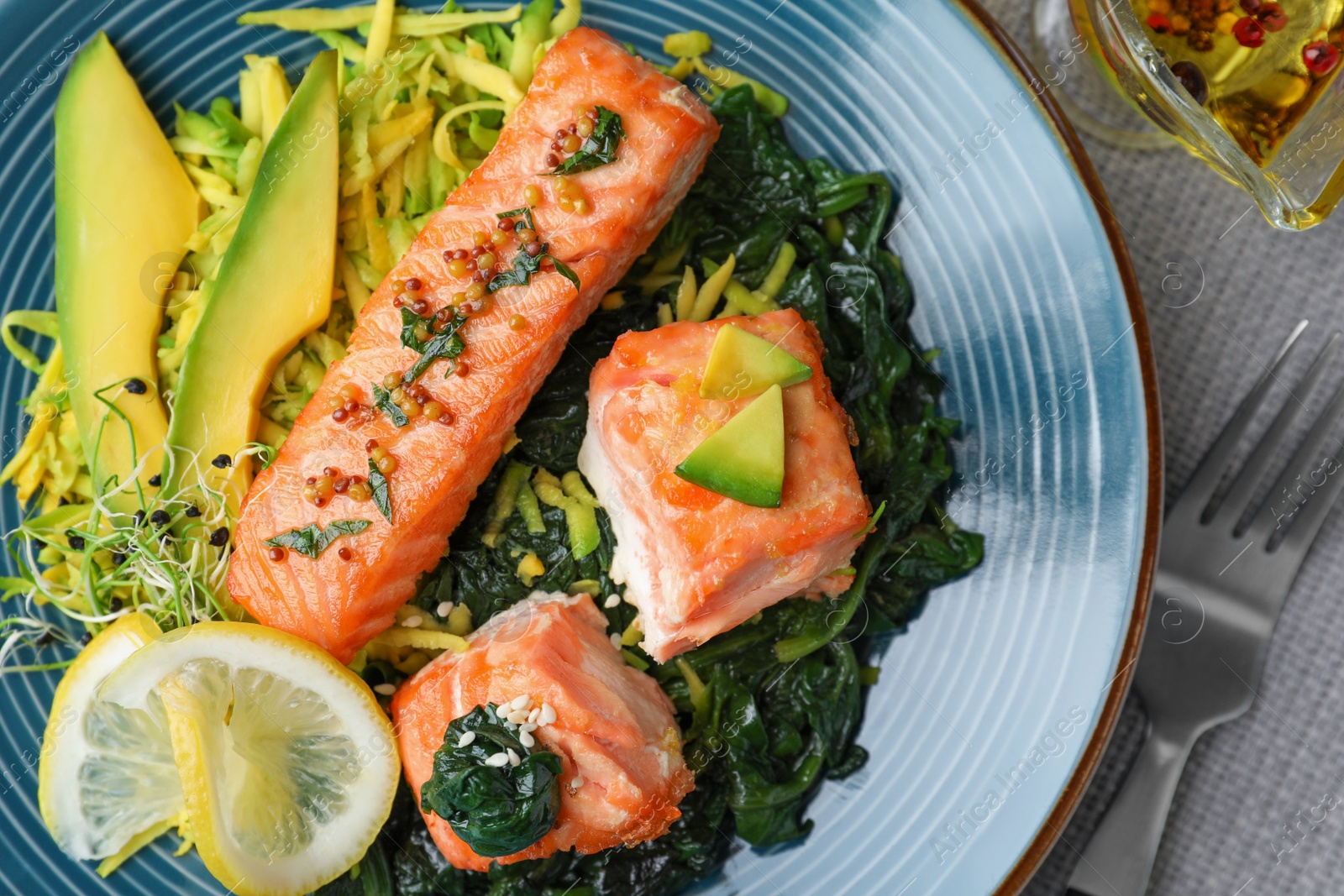 Photo of Tasty salmon with spinach served on table, flat lay