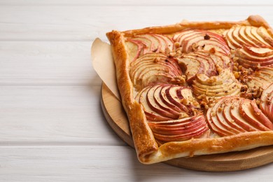 Tasty fresh apple galette on white wooden table, closeup. Space for text