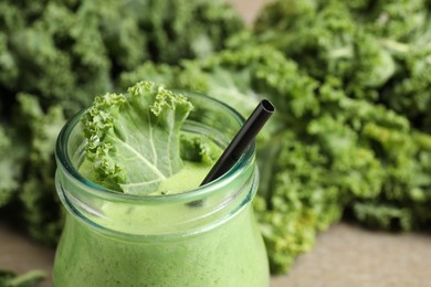 Tasty fresh kale smoothie on table, closeup