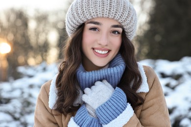 Portrait of smiling woman in snowy park