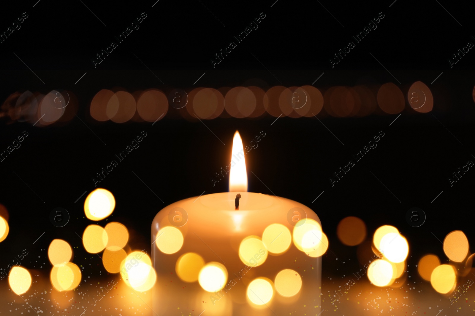 Image of Burning candle on dark background, bokeh effect