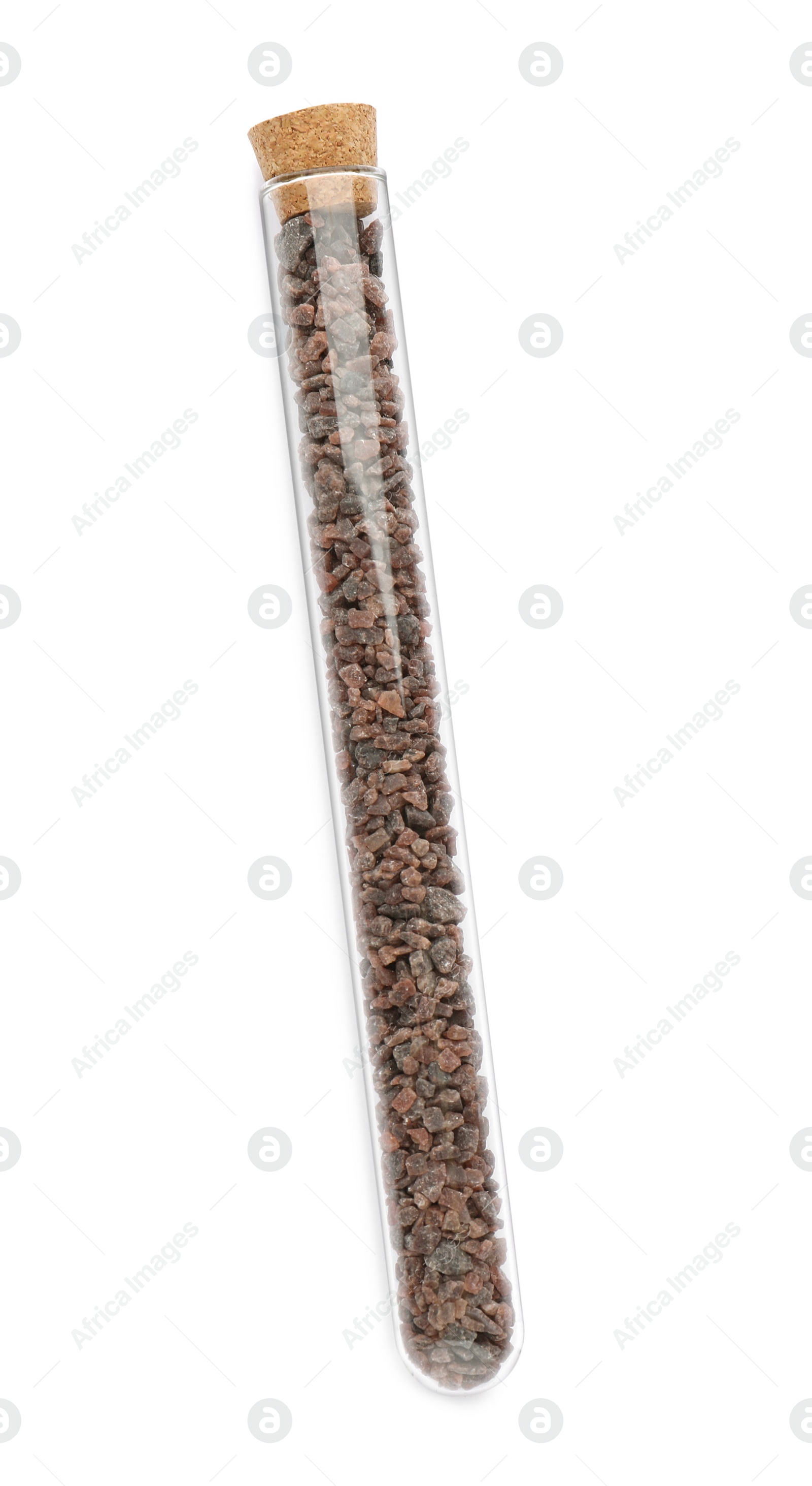 Photo of Glass tube with black salt on white background, top view