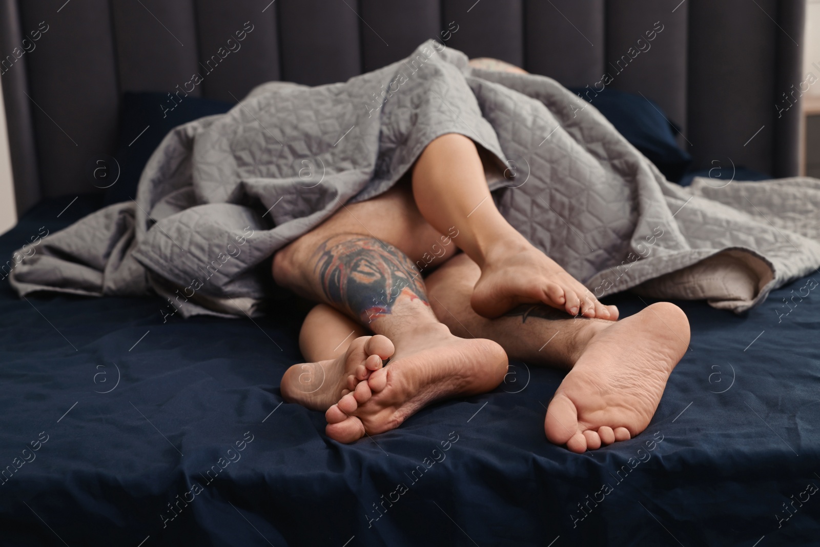 Photo of Passionate couple having sex on bed at home