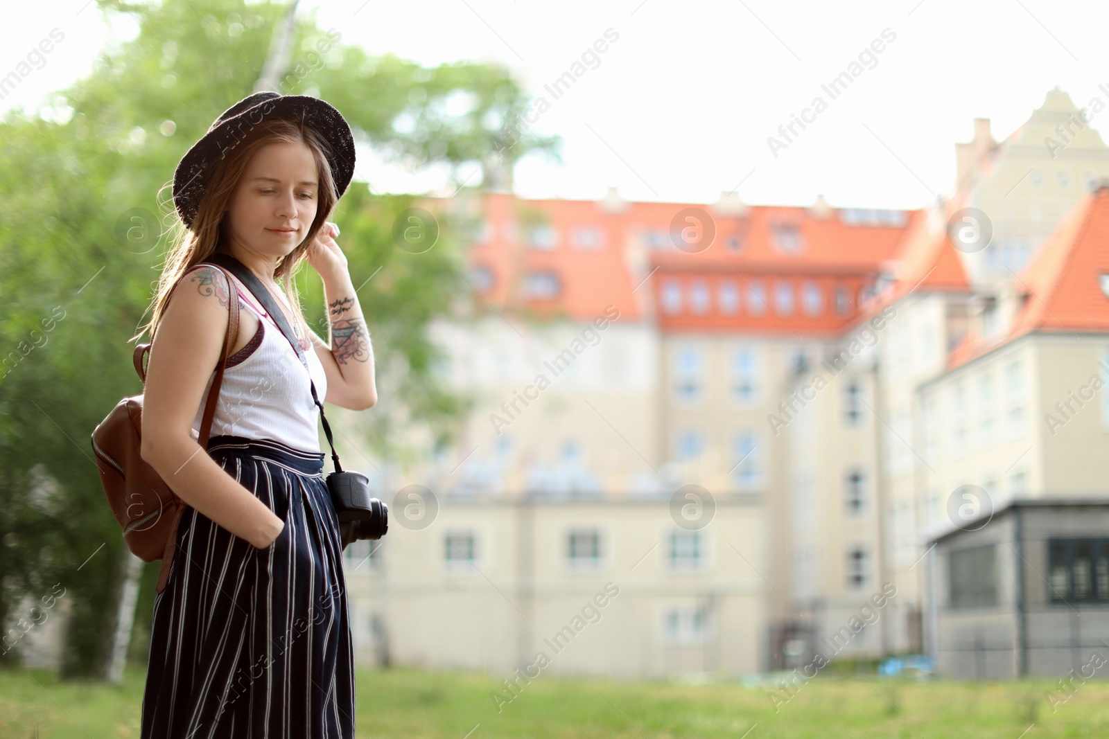 Photo of Young woman with camera on city street