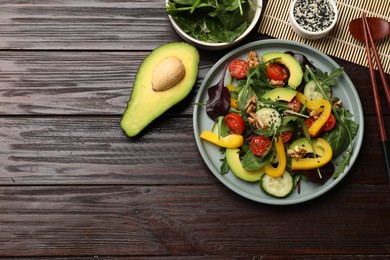 Photo of Balanced diet and vegetarian foods. Plate with different delicious products on wooden table, flat lay. Space for text