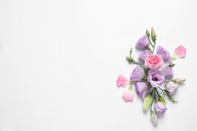 Beautiful Eustoma flowers on white background, top view. Space for text