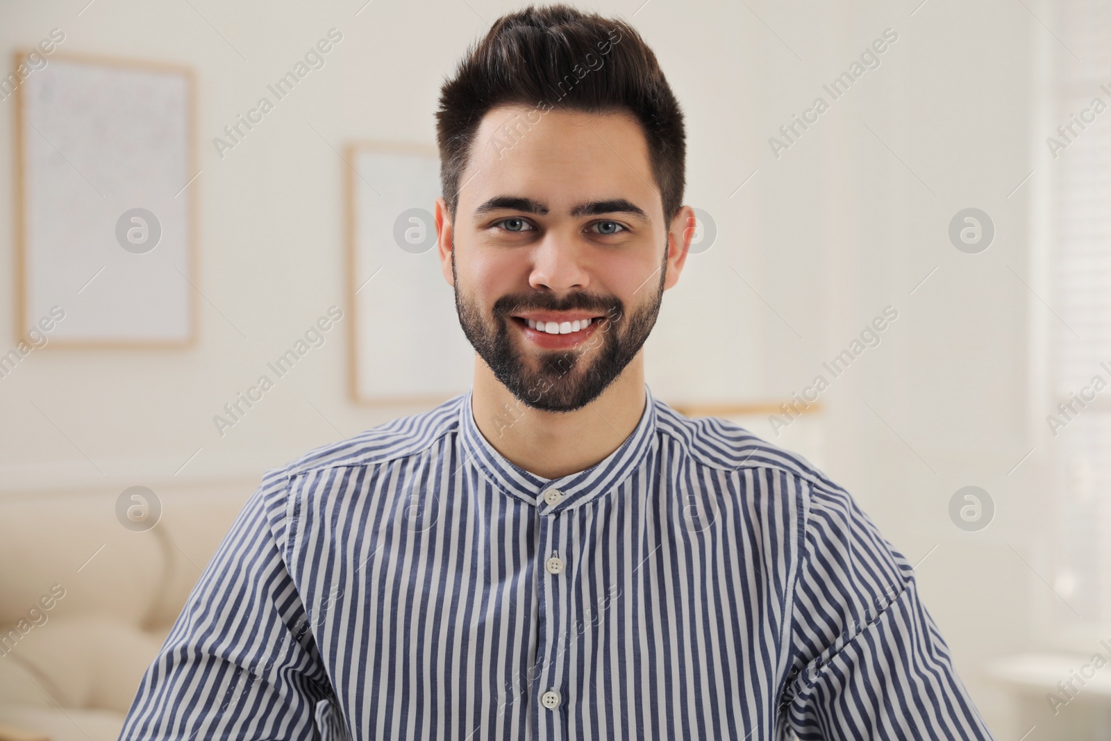 Photo of Portrait of happy young man in room