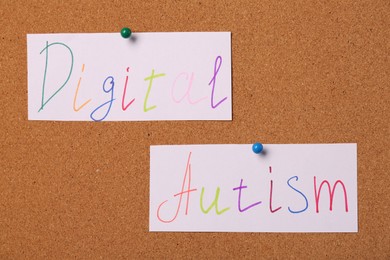 Photo of Cards with words Digital Autism pinned on corkboard