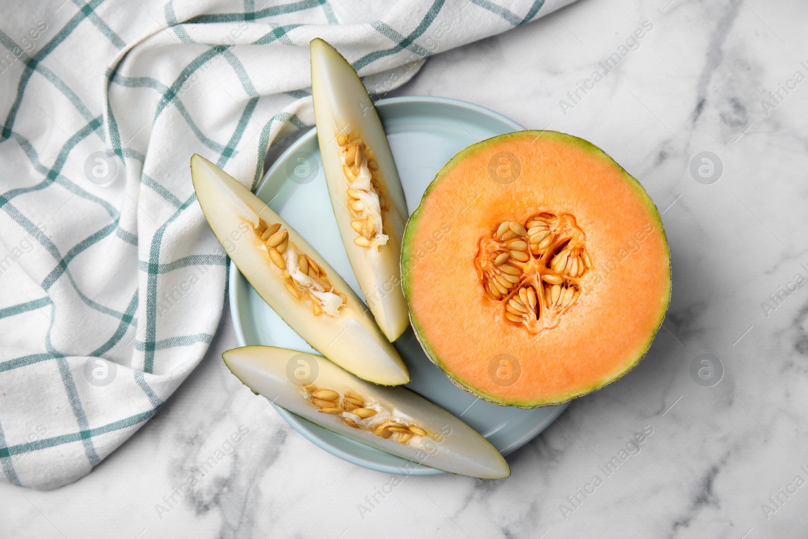 Photo of Tasty colorful ripe melons on white marble table, top view