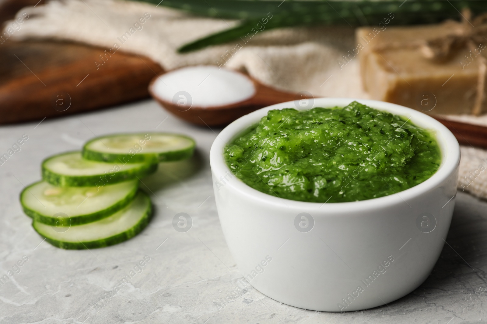 Photo of Handmade face mask and ingredients on grey table