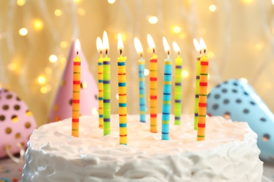 Delicious birthday cake with burning candles, closeup