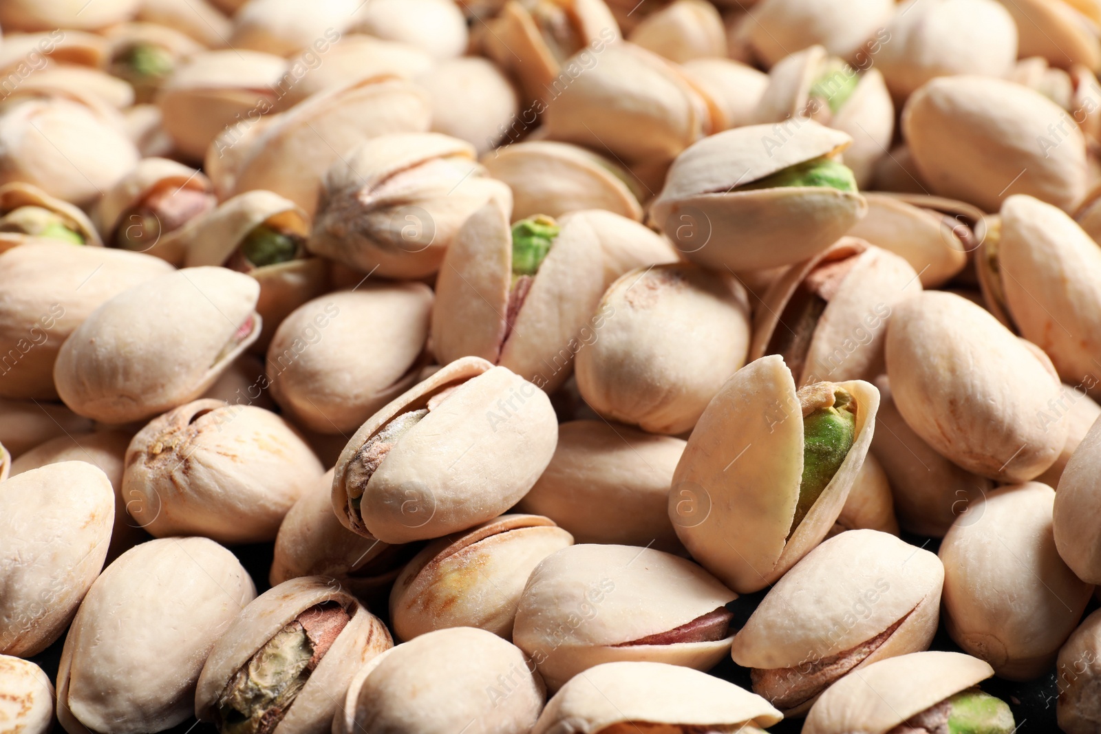 Photo of Organic pistachio nuts in shell as background, closeup